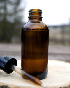 CBD Oil in Bottle with Dropper. Use CBD Oil for migraine treatment.
